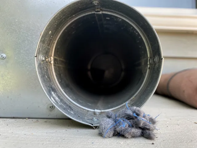 West Hartford Dryer Vent Cleaning technician using specialized equipment to clear severe dryer vent blockage in West Hartford